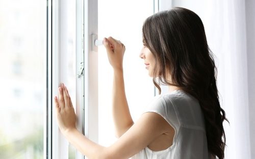 Woman locking a window