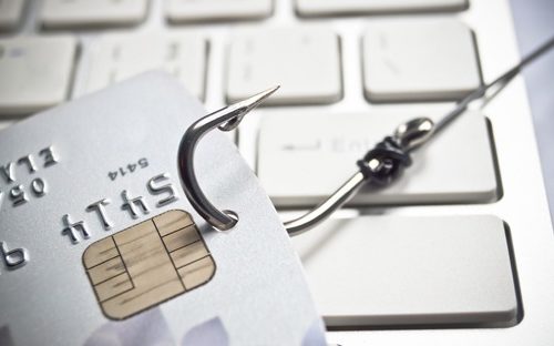 Fishing hook through a credit card indicating a phishing scam